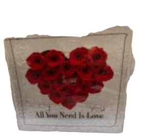 Alternative view of natural preserved heart flowers in a glass box